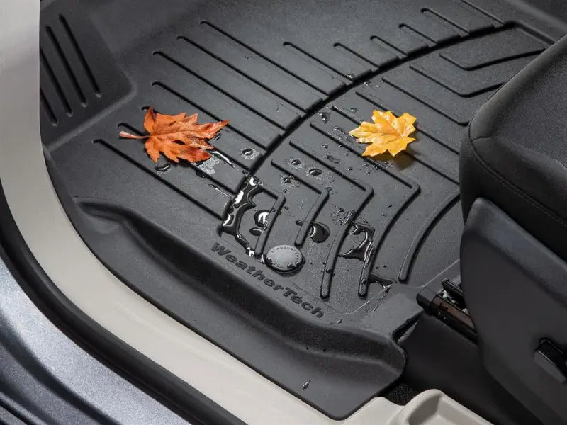 Black floor liner molded fit with ridges and channels for fluid control WeatherTech logo