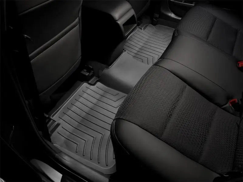 Gray car floor liner molded fit with channels and reservoir for fluids, WeatherTech logo