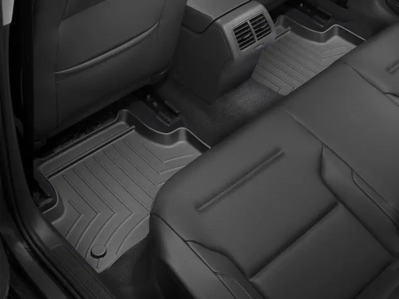 WeatherTech FloorLiner Molded Fit with channels and reservoir for fluid control in black TPO material, rear seat view.
