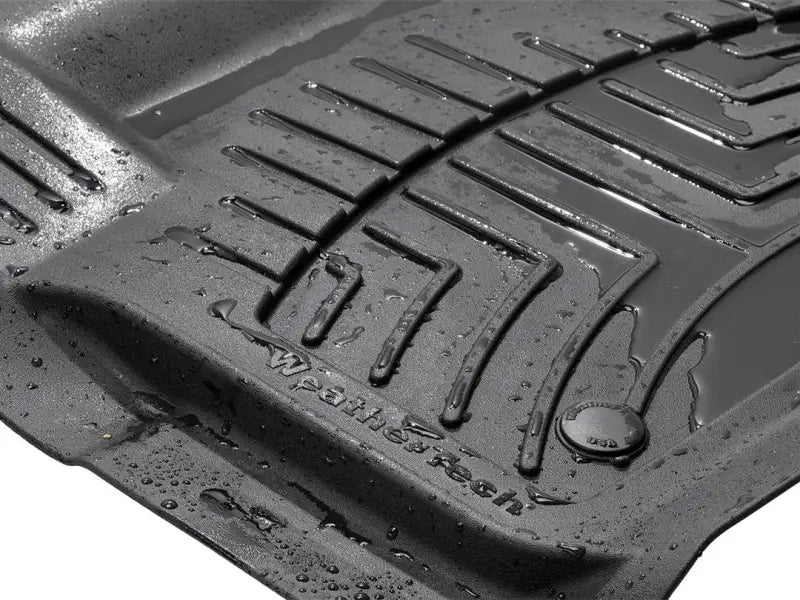 Black WeatherTech floor liner molded fit with textured grooves and water droplets