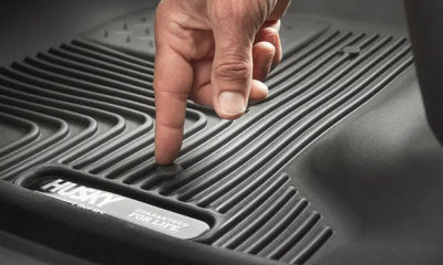 Husky Liners black thermoplastic elastomer floor liner, molded fit, raised ridge, and stay-put cleats.