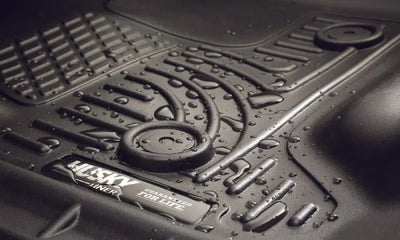 Husky Liners X-act Contour floor liner in black, molded fit, thermoplastic elastomer material, with raised ridge and StayPut cleats, designed for trucks and SUVs.