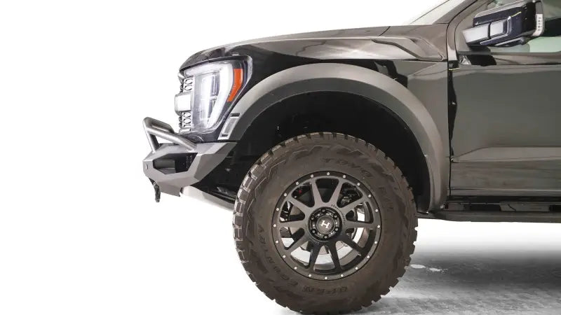 FR21-X5351-1 Fab Fours Matrix Front bumper installed on a black vehicle, showcasing its rugged and sleek design for premium front-end protection.