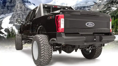 Ford Super Duty truck with FS17-U4150-1 Fab Fours Elte Rear bumper, showcasing rugged durability against a mountain backdrop.