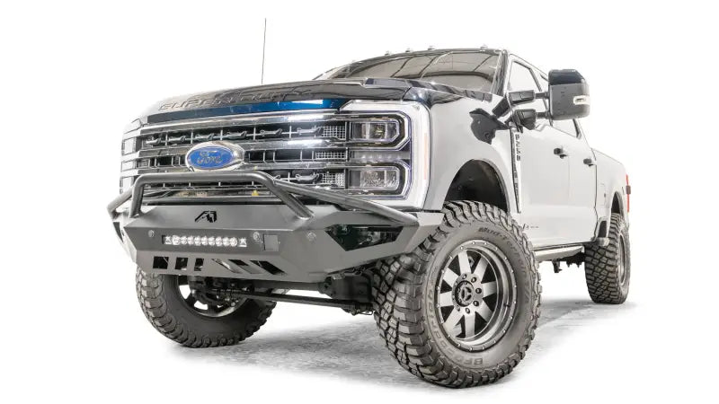Fab Fours FS17-V4152-1 Vengeance Front Bumper on a 2017 Ford F250, showcasing a heavy-duty design with an integrated 20" LED light bar, winch-ready feature, and rugged appearance enhancement.