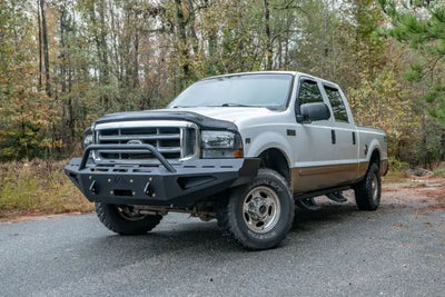 Fab Fours FS99-RS1662-1 red steel bumper on 1999-2004 Ford Super Duty F250-F550, enhancing rugged style and off-road protection.