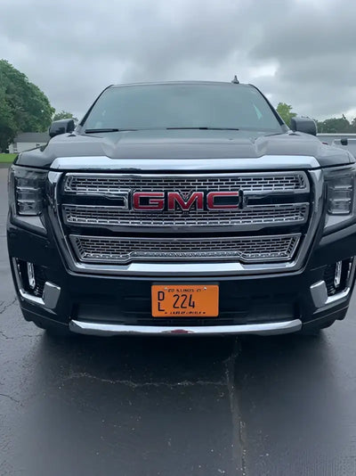 Front view of a black GMC Yukon XL showcasing GI179BLK Coast2Coast glossy black wheel covers, providing a sleek and sophisticated upgrade.