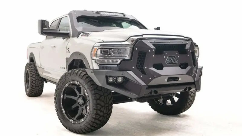 GR4400-1 Fab Fours Dodge Grumper installed on a white Dodge truck, showcasing its rugged and aggressive front-end design for enhanced durability and protection.