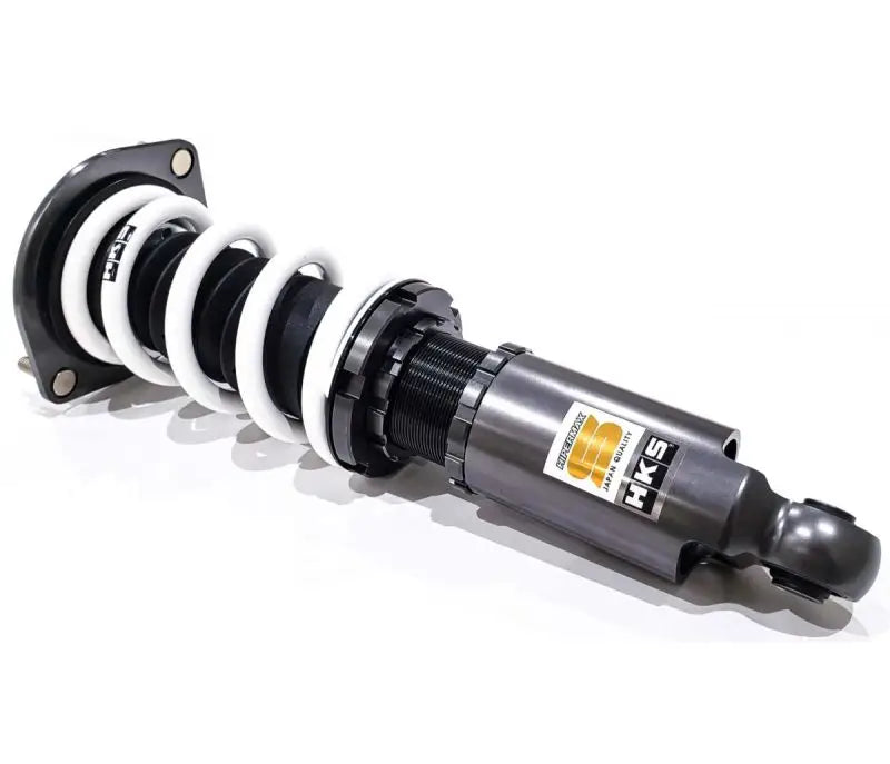 Gray and black coilover suspension with a white spring.