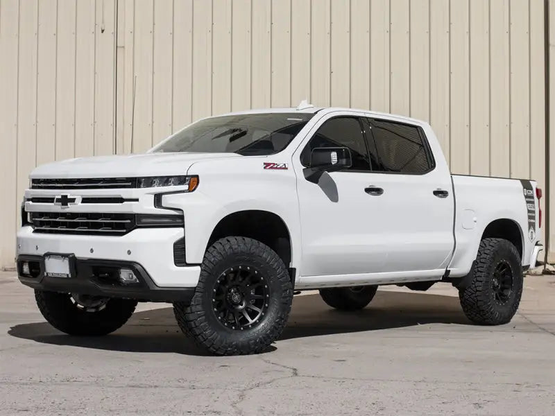 "White Chevrolet Silverado with ICON 2019+ GM 1500 1.5-3.5in Stage 2 Suspension System featuring billet aluminum upper control arms"
