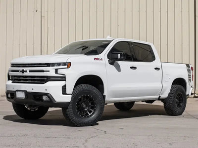 White Chevrolet Silverado 1500 truck with ICON 2019+ GM 1500 1.5-3.5in Stage 4 Suspension System and billet upper control arms.