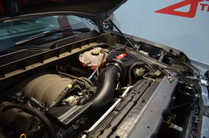 Car engine bay with aftermarket Chevrolet Silverado V8-5.3L Evolution Intake upgrade