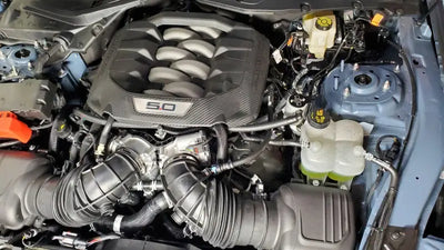 Car engine compartment with J&L 2024 Ford Mustang 5.0L oil separator close-up