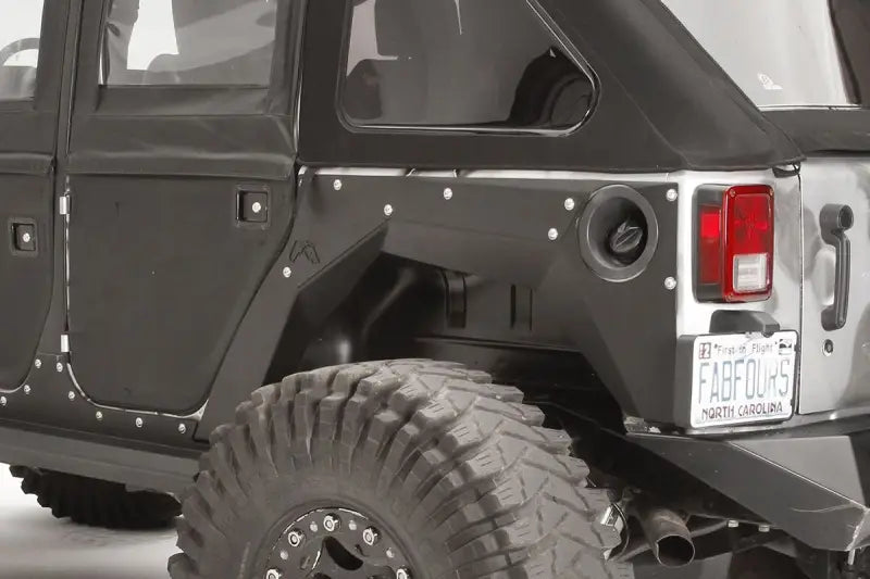 JK1001-1 Fab Fours Rear Fender installed on a Jeep Wrangler JK, showcasing durable construction and sleek design.