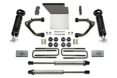 Fabtech K1071DL Lift Kit Suspension components including shock absorbers, control arms, bolts, and brackets designed for enhanced ground clearance and off-road performance.