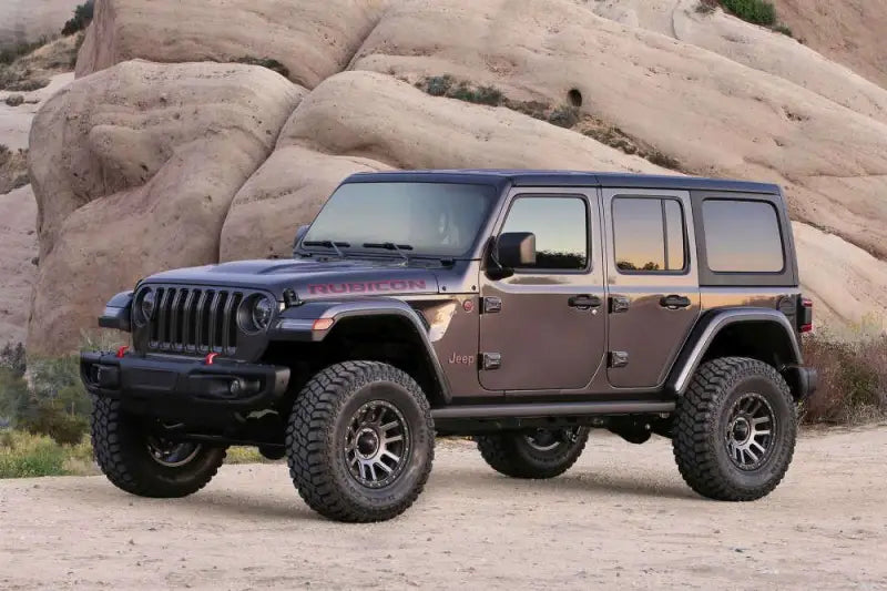 Off-road 2018 Jeep Wrangler JL 4WD 4-door with K4117M Fabtech 3' Trail lift kit and Stealth design for enhanced ground clearance and rugged appearance.
