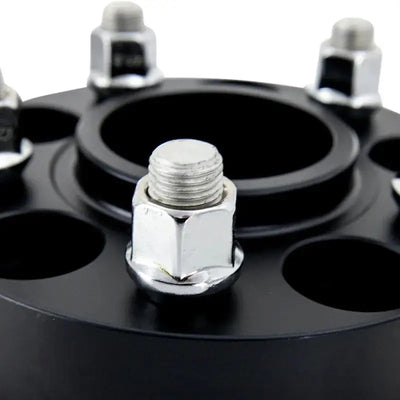 Black Mishimoto 5x114 15mm wheel spacers with lug nuts for better fitment