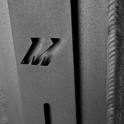 Textured metal with cut-out Mishimoto logo on dual pass intercooler dual side inlet/outlet
