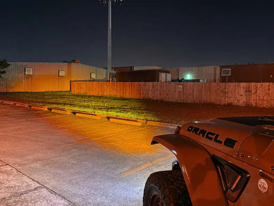 a jeep parked in a parking lot at night