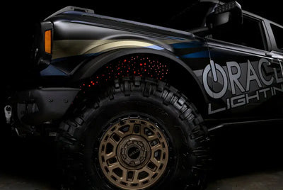 Black Ford Bronco with custom lighting featuring Oracle Lighting Fiber optic wheel liners
