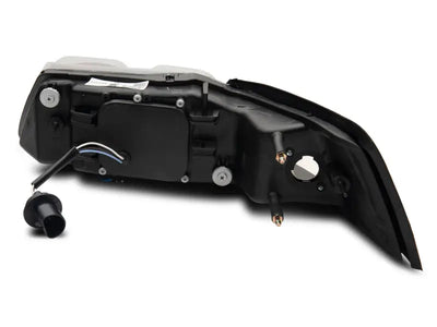 Rear car light assembly showing Raxiom LED halo projector headlights for Ford Mustang