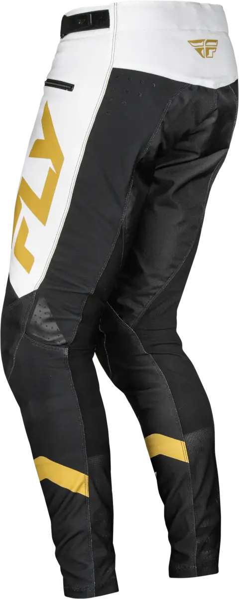 Black and white motocross pants with gold accents showcasing durable stretch technology for riding