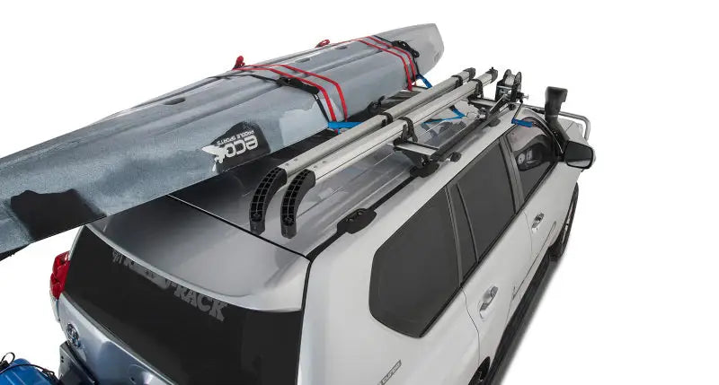White SUV with roof rack and kayak using Rhino-Rack Nautic Kayak Lifter for easy transport
