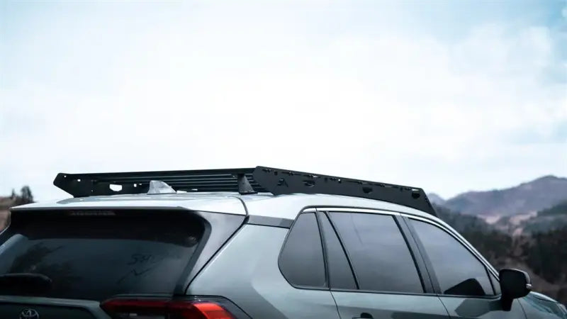 Gray SUV with a black anodized roof rack that’s a direct fit and includes crossbars