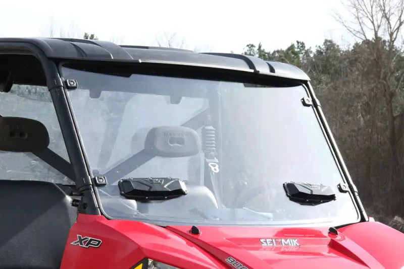 Red Polaris XP off-road vehicle with Seizmik Versa-Vent Windshield Poly and clear windshield