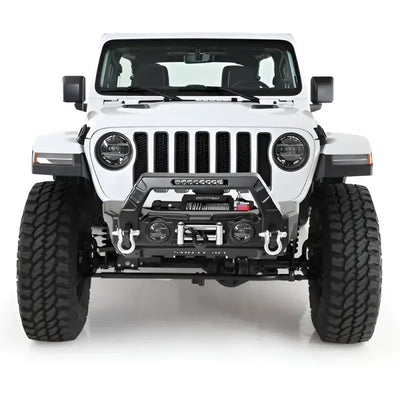 Front view of a rugged white off-road vehicle featuring the Smittybilt Gear Tail Gate Cover in black, enhancing protection and style.
