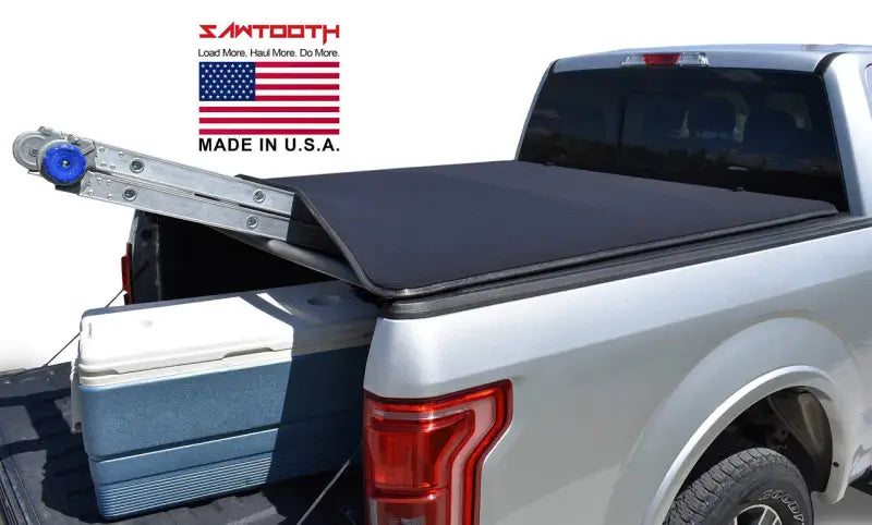 Silver pickup truck with black tonneau cover.