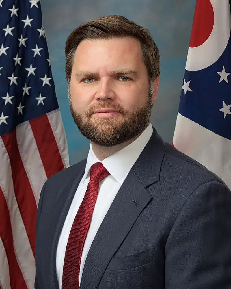 Man in suit with American and Ohio flags behind, showing Vance & Hines universal exhaust tip eliminator